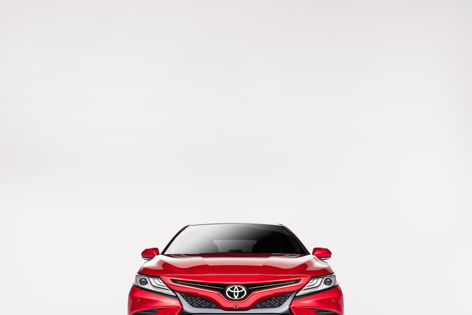 Red Toyota vehicle on light background