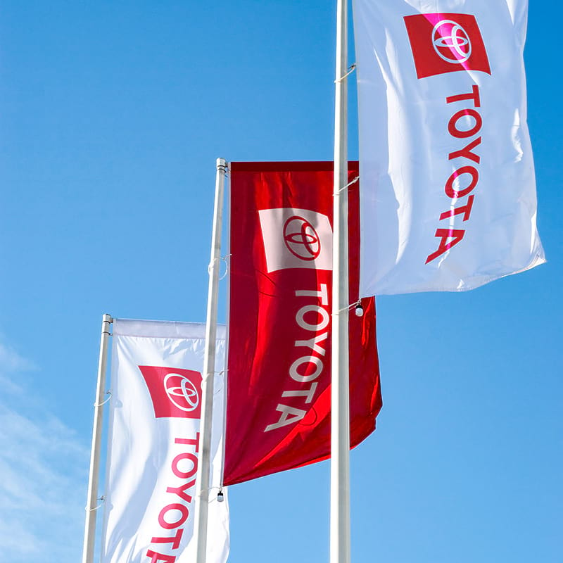 Flags with horizontal brand logos in white and Toyota red