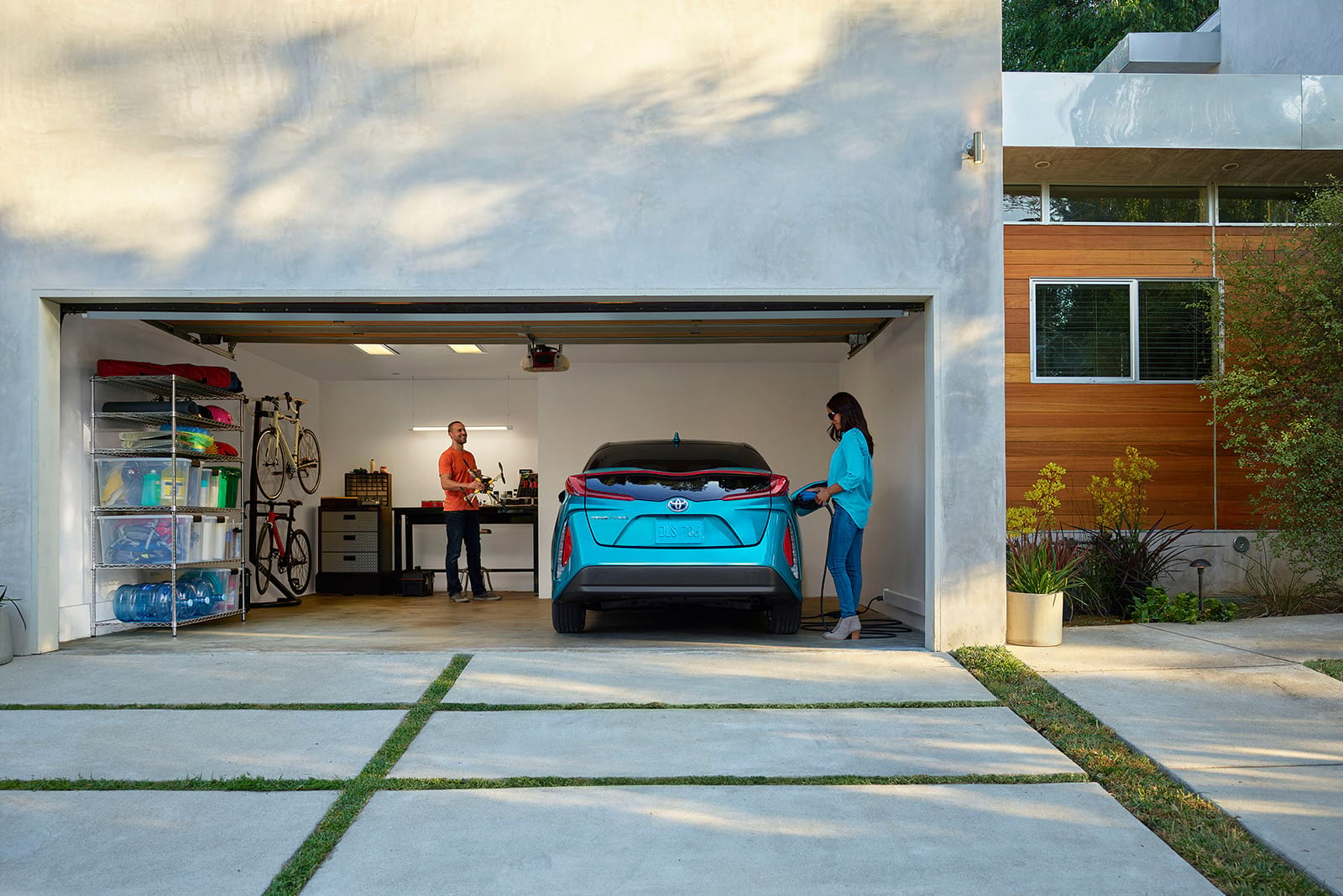 Couple in garage charging Toyota vehicle
