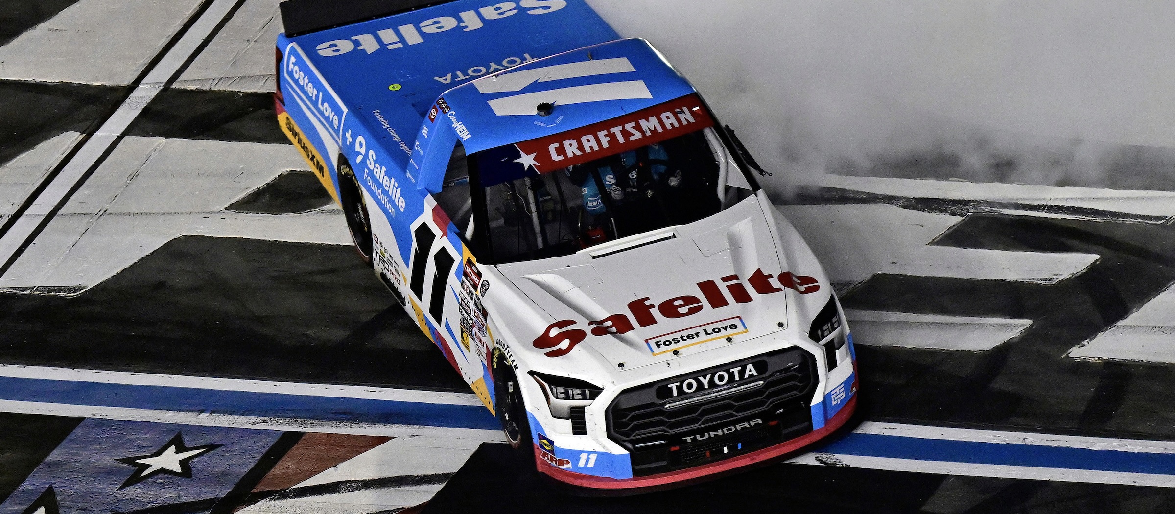 #11: Corey Heim, TRICON Garage, Safelite + Foster Love Toyota Tundra celebrates his win