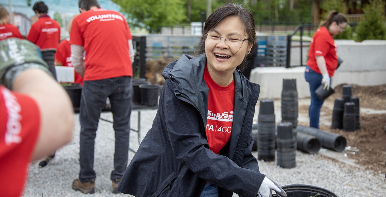 Volunteer moving planters with pollinator plants,Volunteer moving planters with pollinator plants