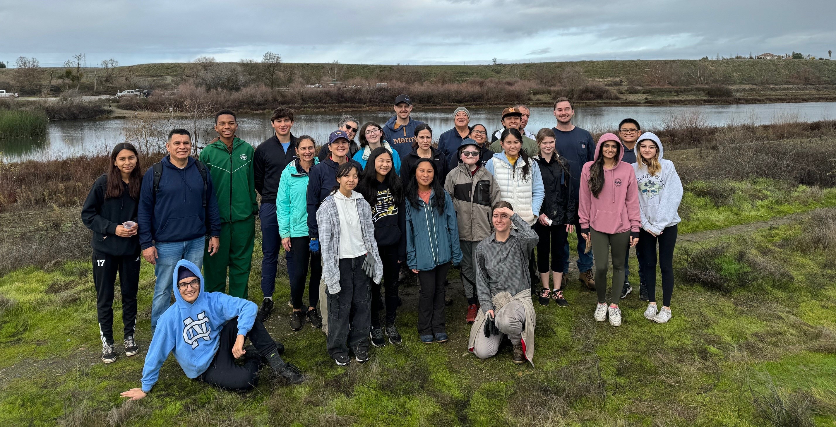 Group of volunteers standing in front of the San Joaquin River in California,