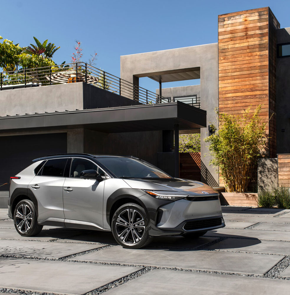 Photo of a 2024 Toyota bZ4X vehicle parked in front of a modern style home