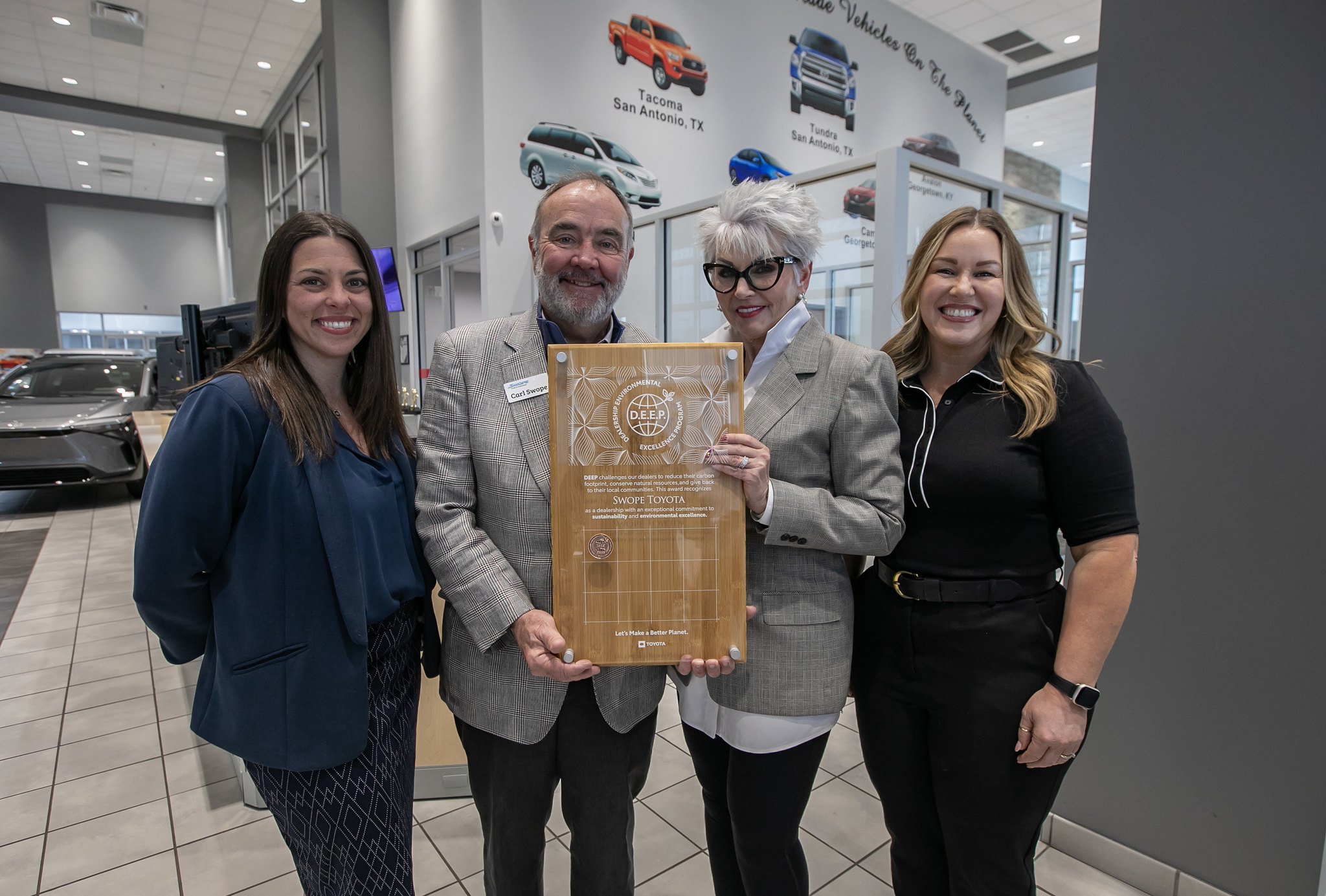 Picture of dealership and Toyota representatives holding award