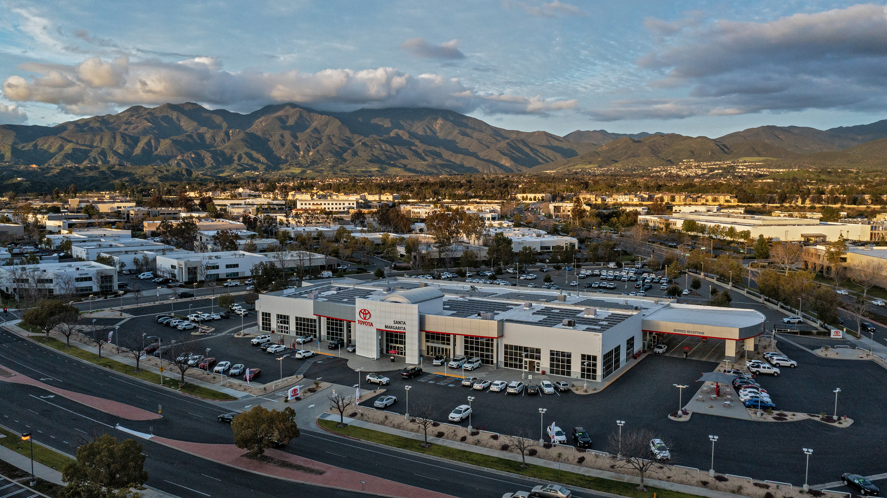 Drone shot of a Toyota dealership in Rancho Santa Margarita, California, which has solar panels on the roof,