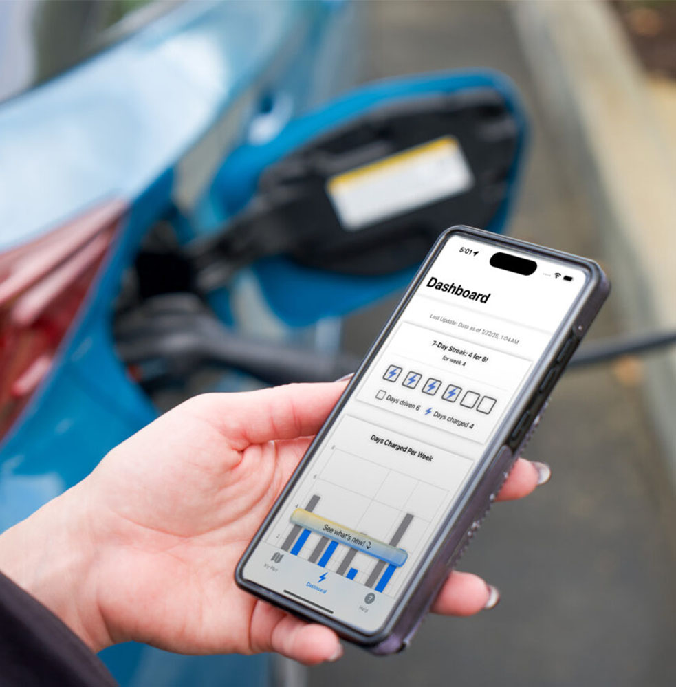 Hand holding phone with an app on screen showing car battery stats