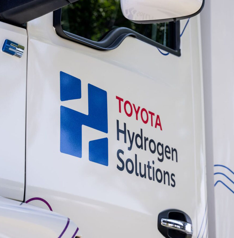 Closeup photo of the Toyota Hydrogen Solutions logo on the door fo a truck